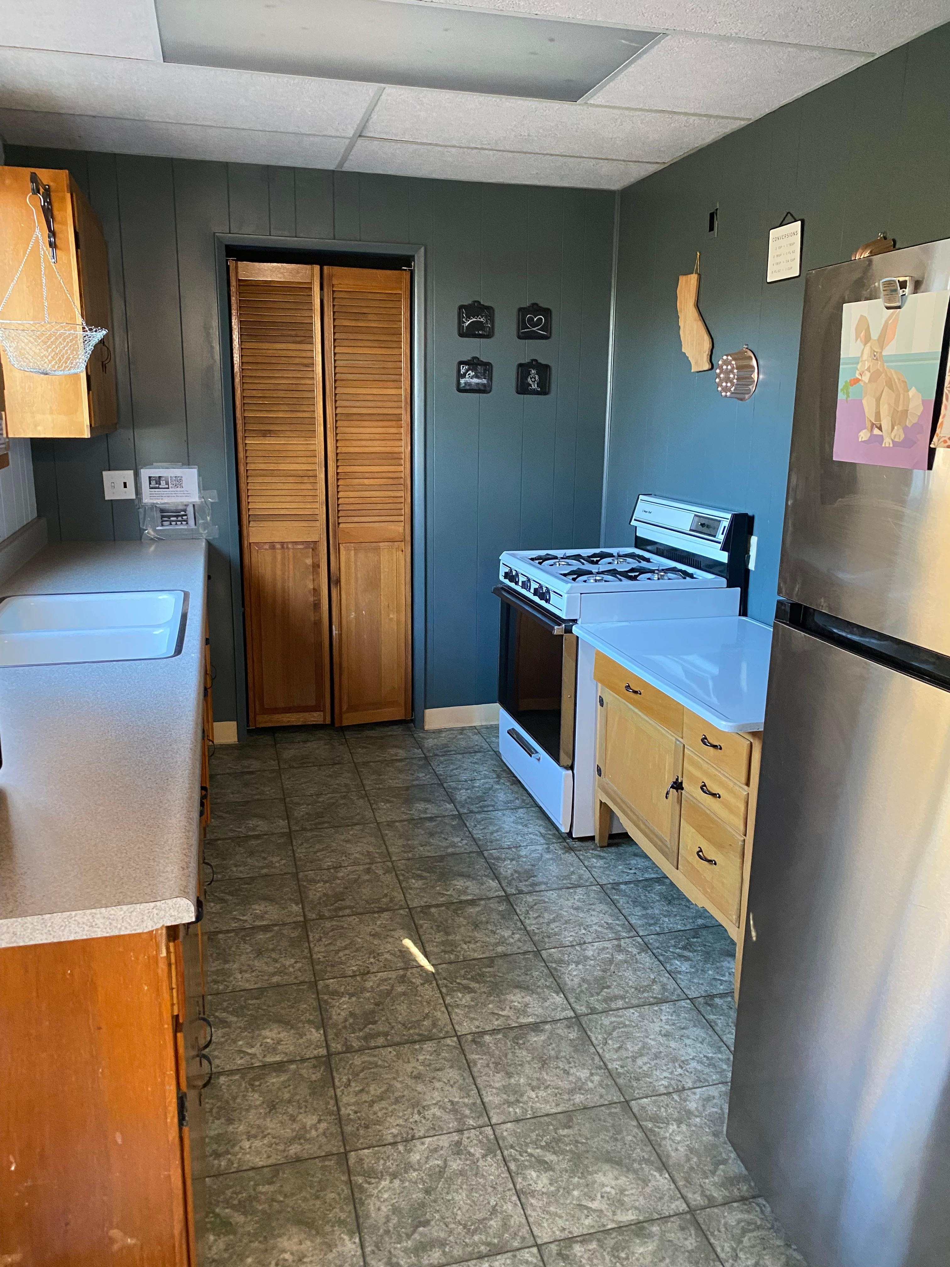 Kitchen, including gas stove, refrigerator, microwave, no dishwasher.