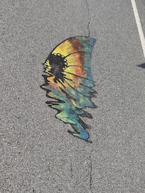 Not sure the meaning but these are painted on the road and on flags hanging from homes.
