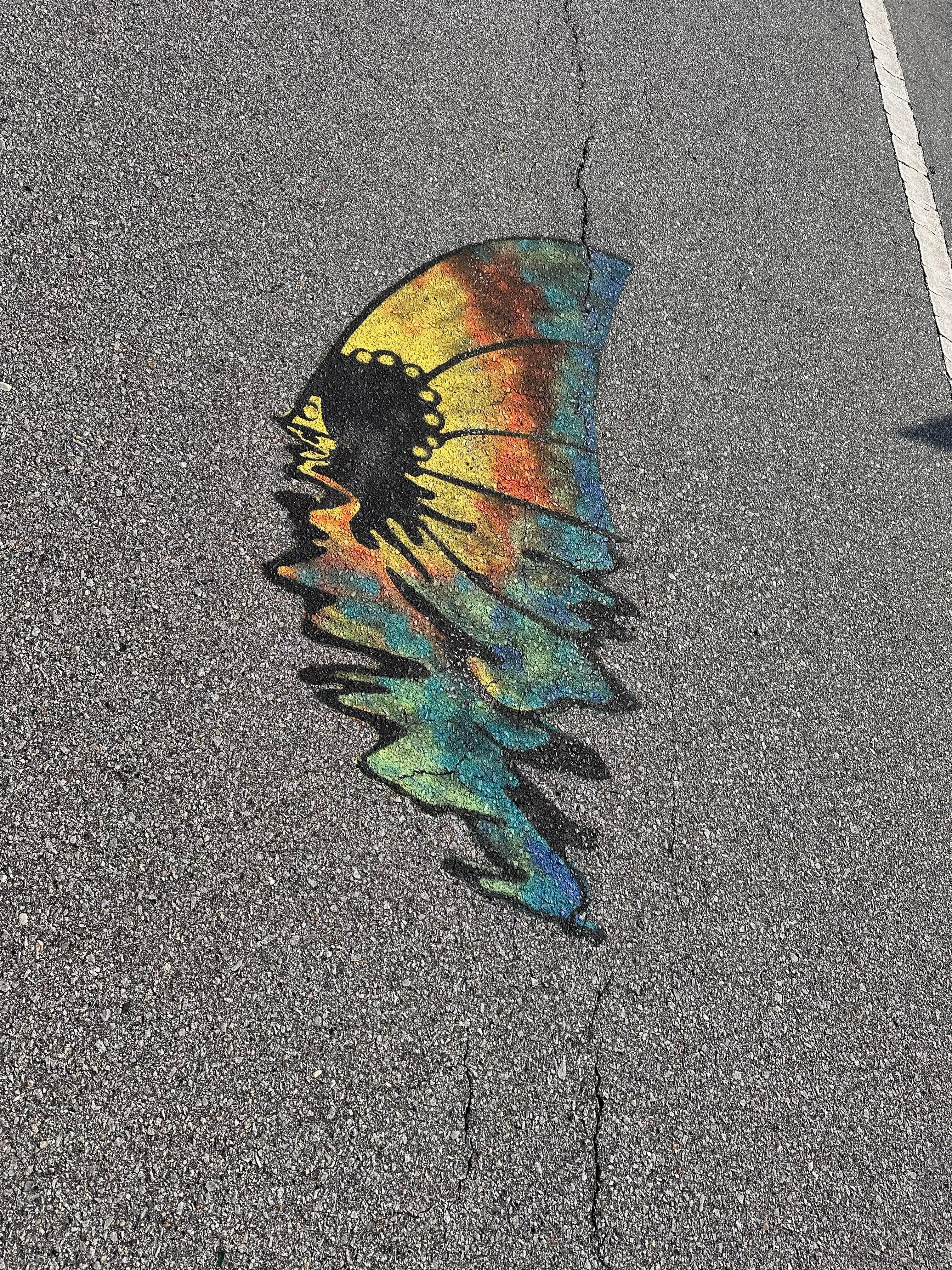 Not sure the meaning but these are painted on the road and on flags hanging from homes.