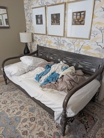 This is a twin bed - you can tell by the overlapping pillow. No way you can fit two adults in this bed.