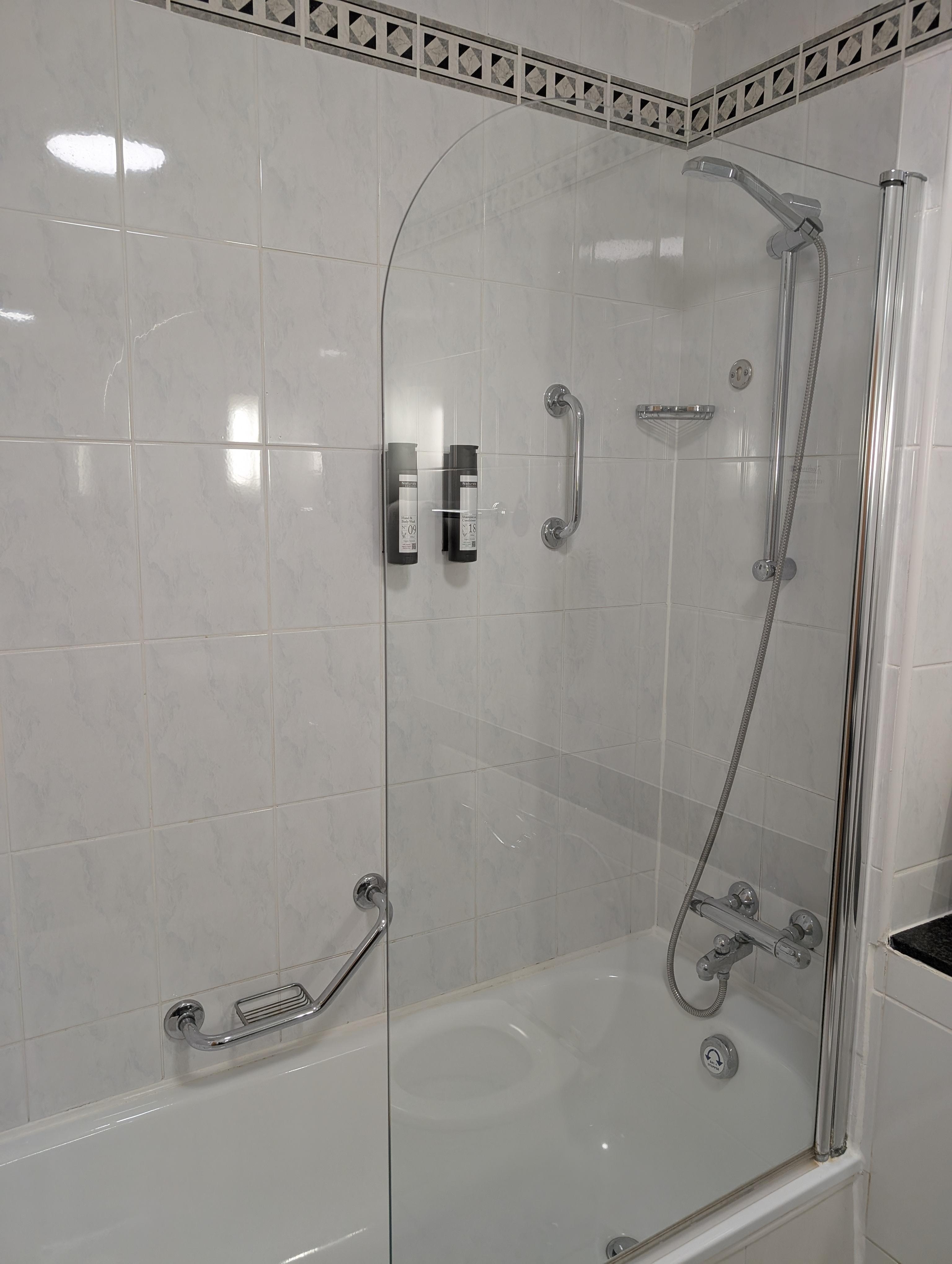 Seal around the bathroom is brown and grout dirty.