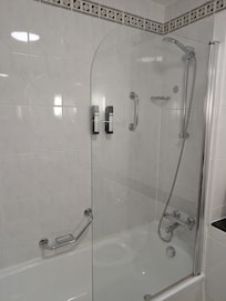 Seal around the bathroom is brown and grout dirty.