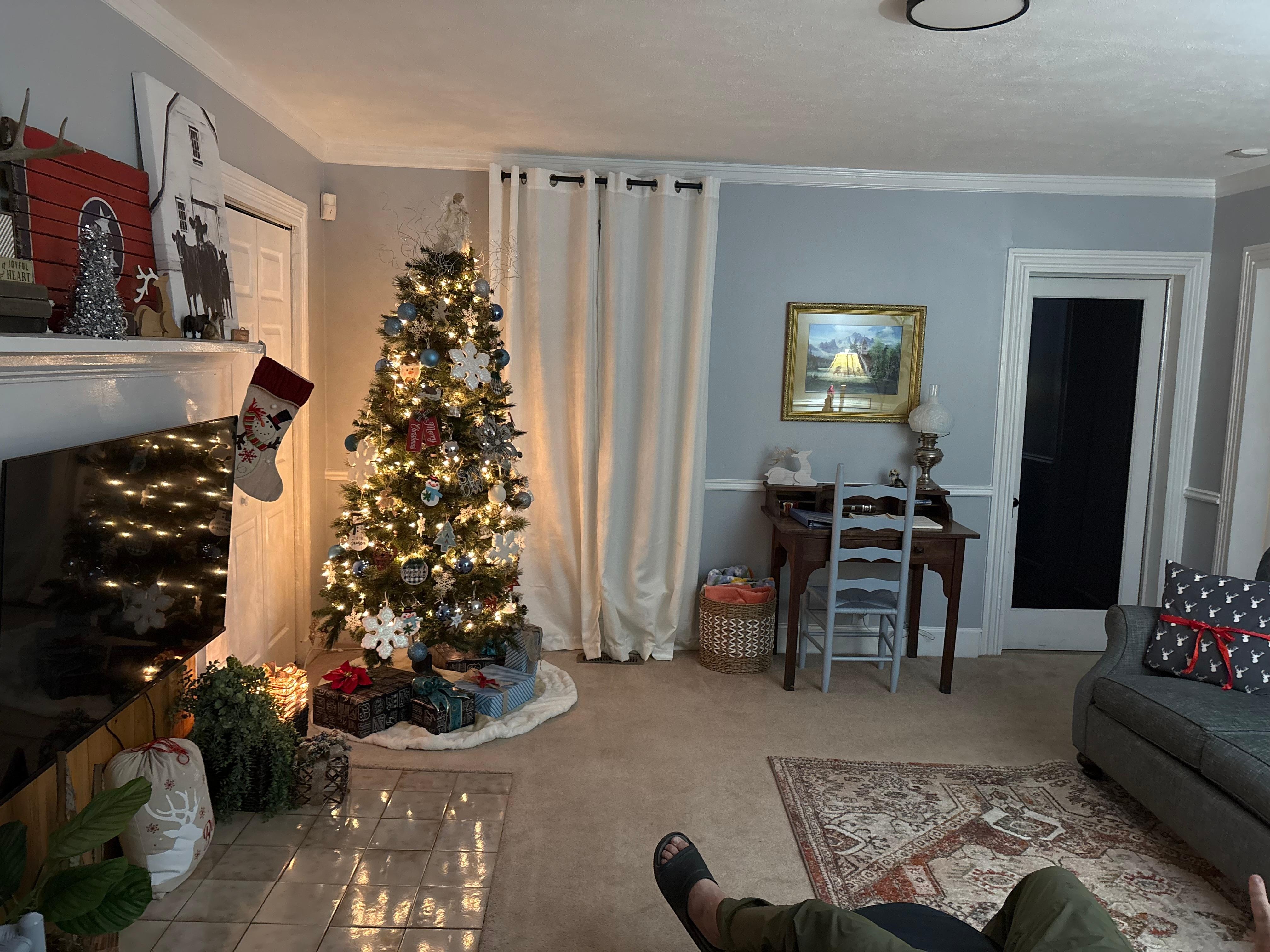 Living room beautiful decor and a warm and bright Christmas tree.