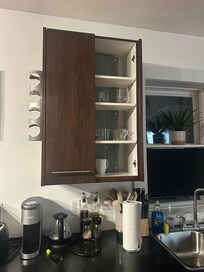 Missing cabinet and dirty dishes.
