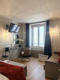 Cozy room with comfortable bed.
An outlet by the glass-top table.
No mini refrigerator in the room.