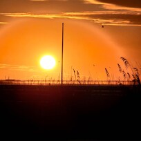 Zoomed in view of the sunrise over the pier from the boardwalk of the property