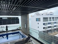 view of hotels in front from pool area of the “beachfront” hotel