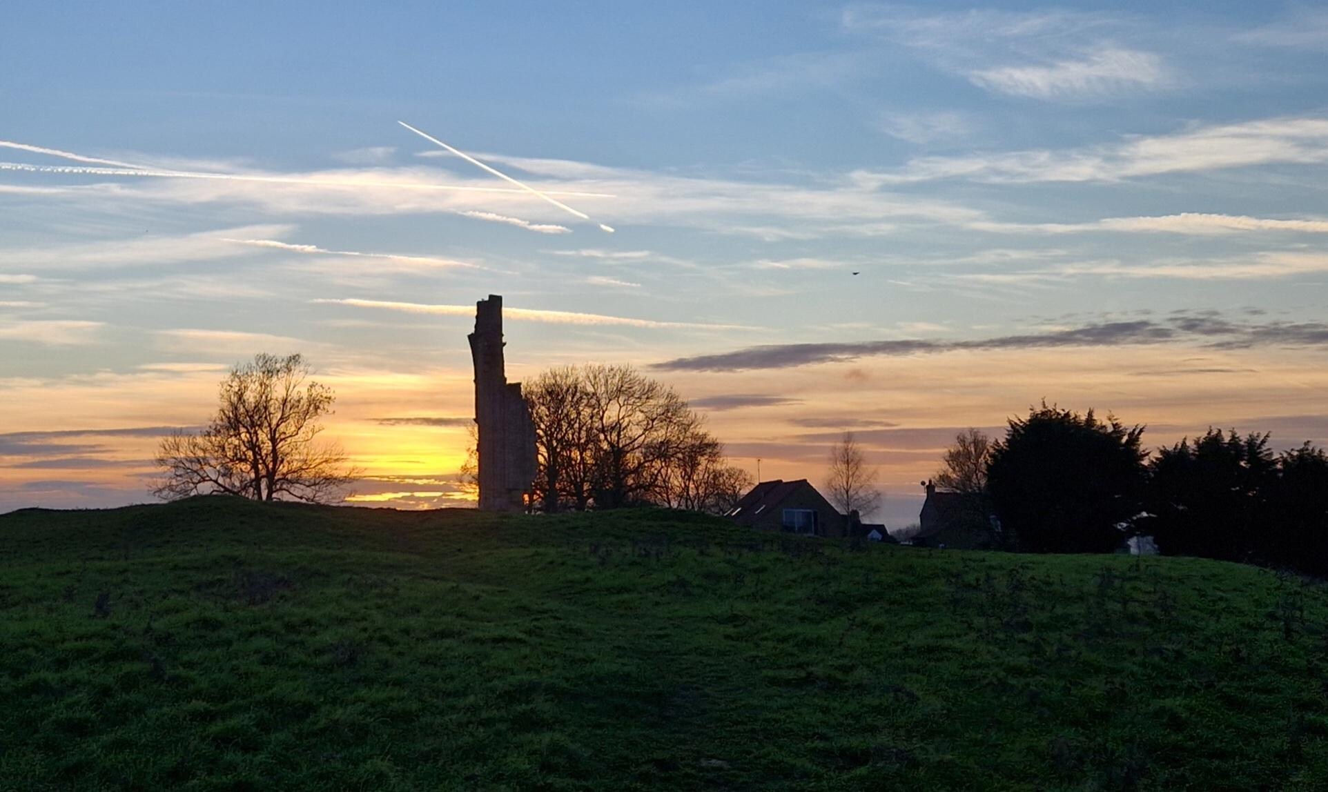 The cottage and Barlings Abbey at sunset