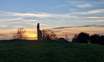 The cottage and Barlings Abbey at sunset