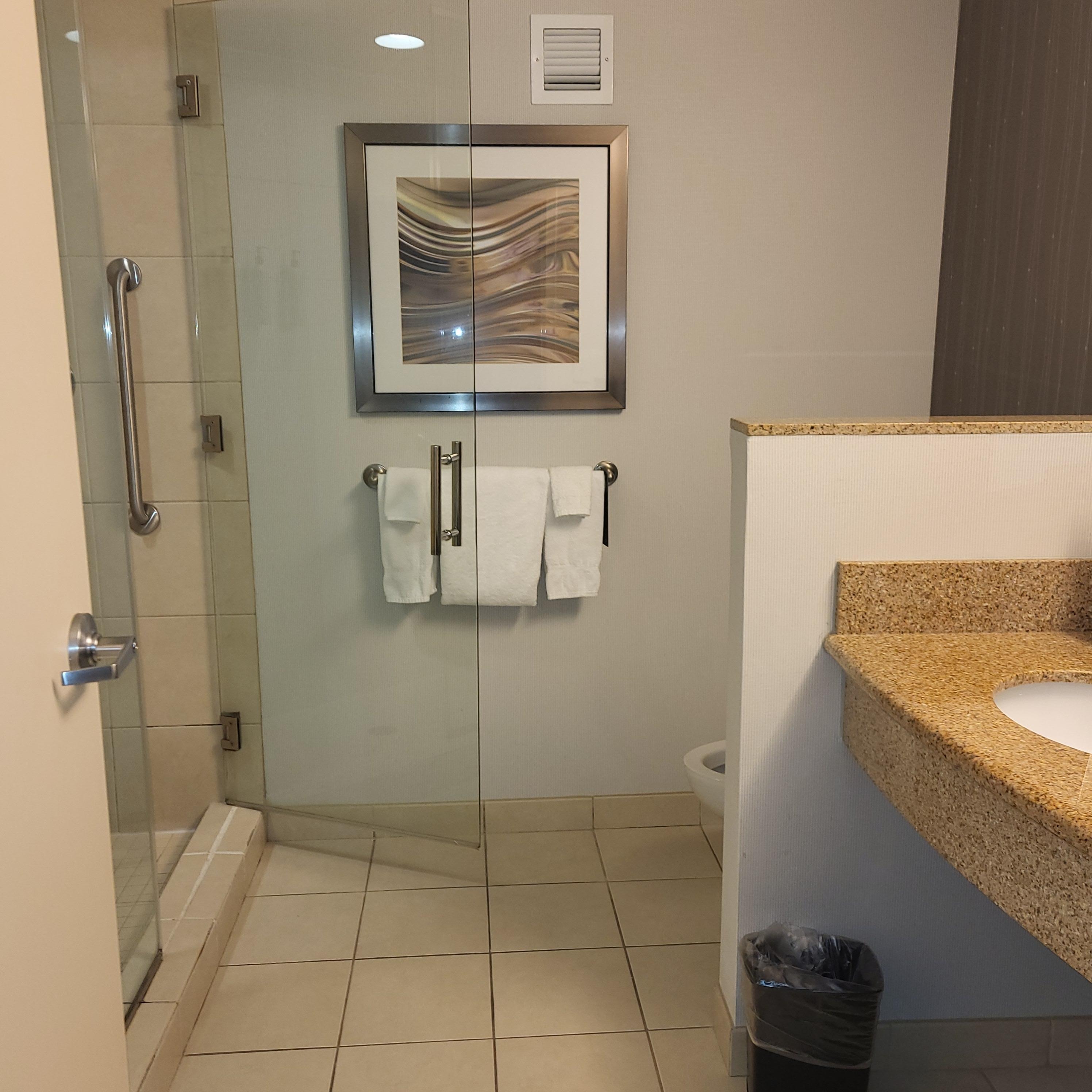 Very neat and clean bathroom with more than enough towels. 