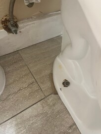 Cardboard propping up the toilet