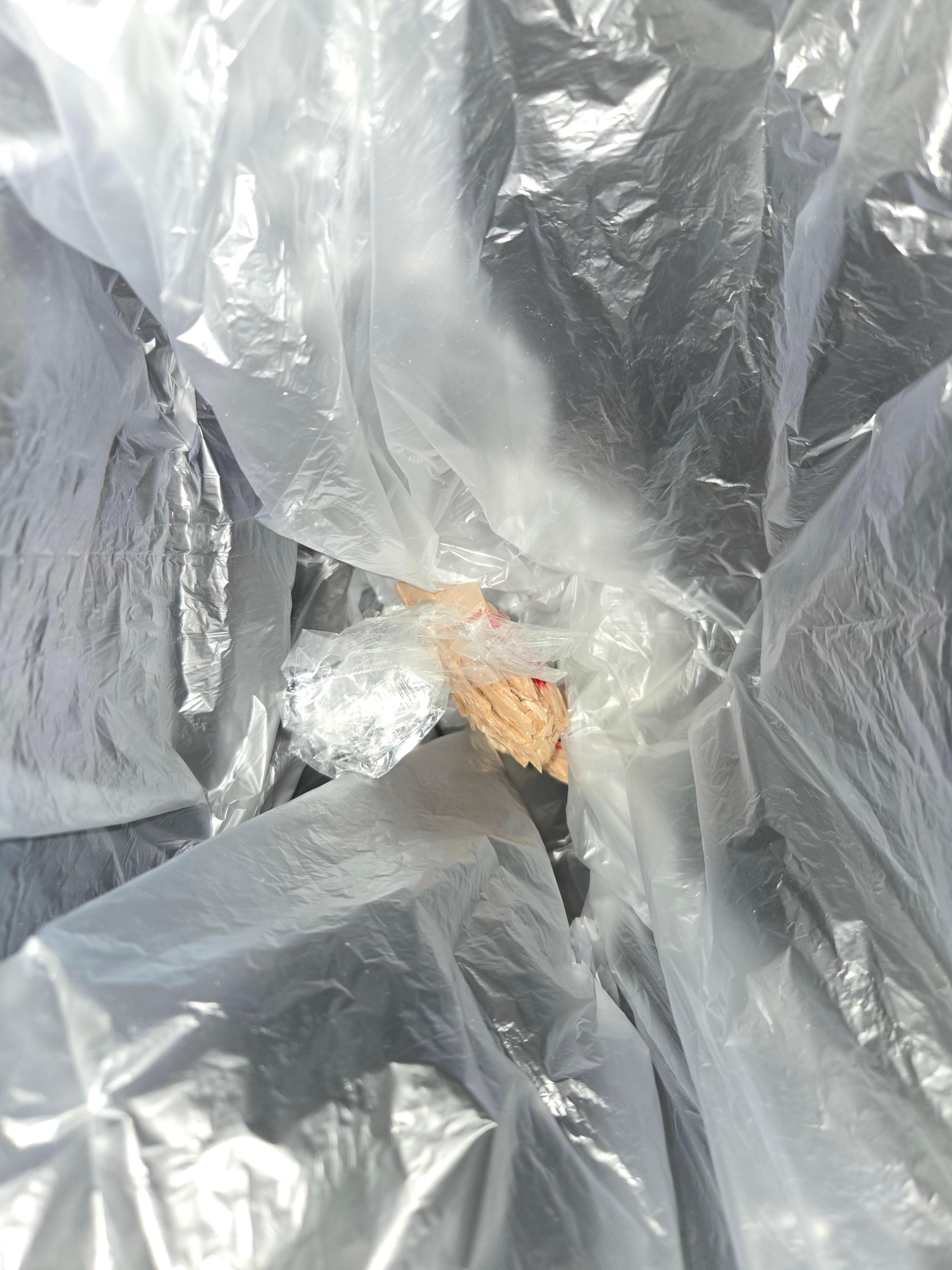 Cellophane wrapper found hidden under mattress. Clearly contained drugs.