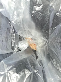 Cellophane wrapper found hidden under mattress. Clearly contained drugs.