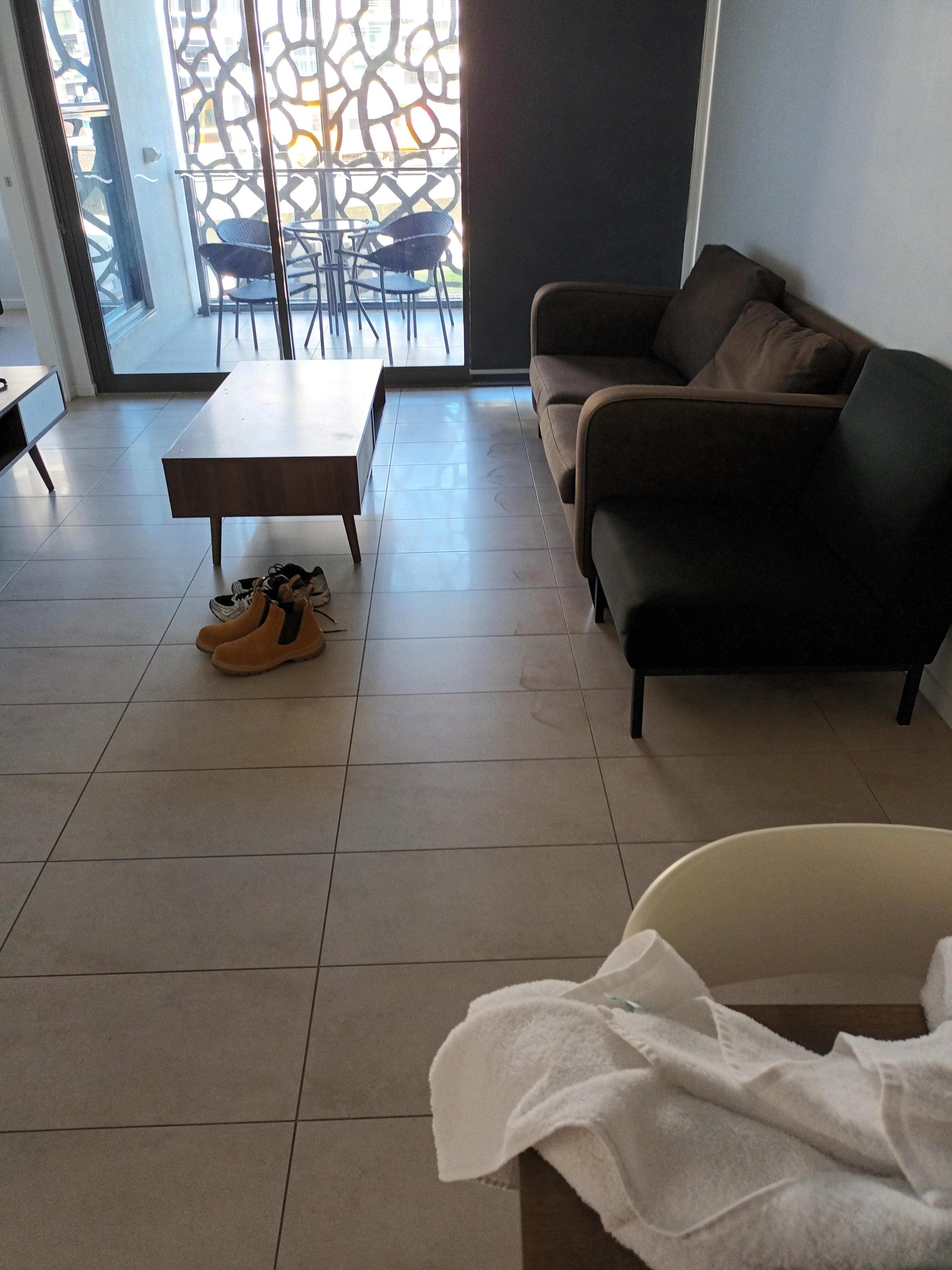 Dirty floor in front of the couch