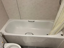 Moldy disgusting tub/shower with disgusting shower curtain