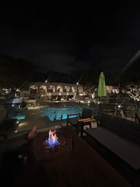 Patio area above pool with fire pit
