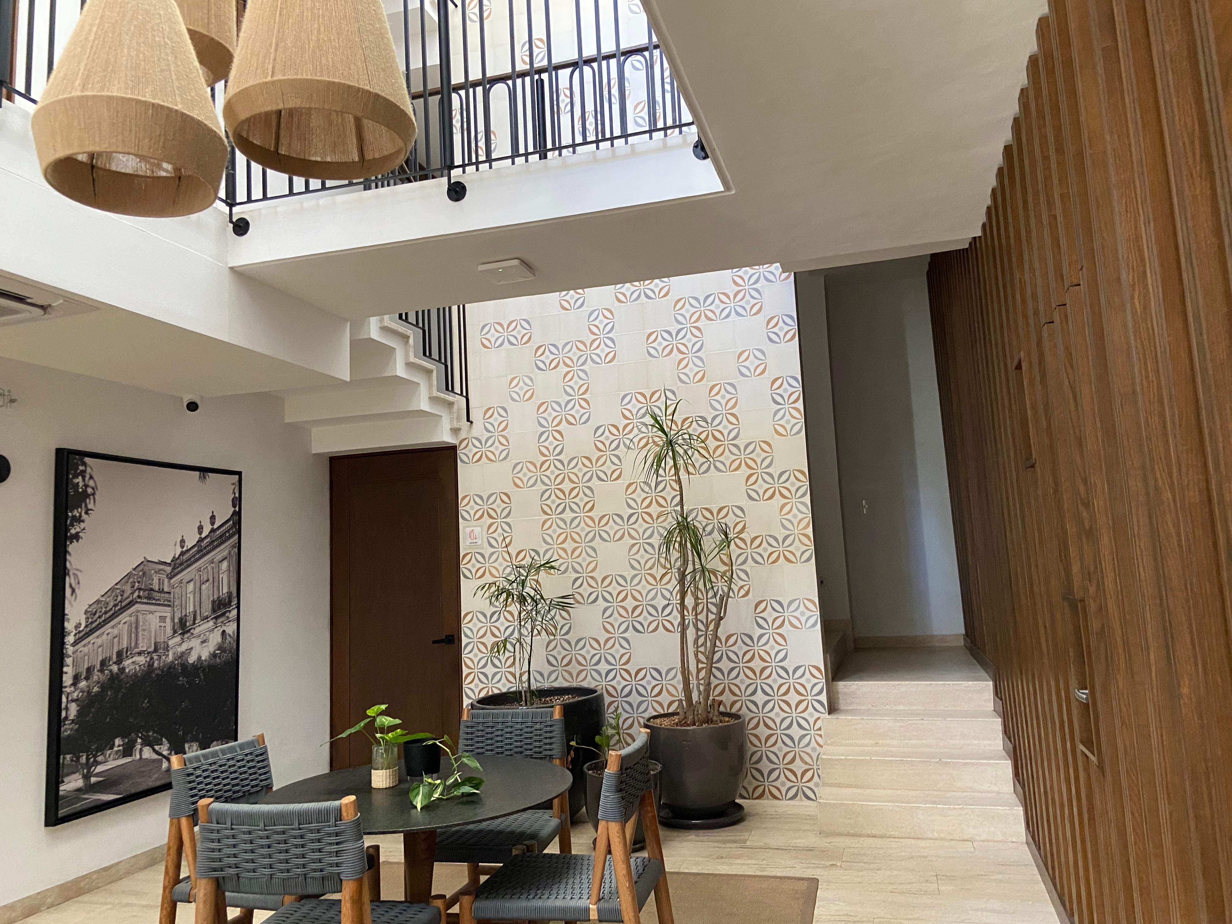 Part of lobby area showing stairs to 2nd floor and pool area. 