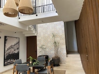 Part of lobby area showing stairs to 2nd floor and pool area.