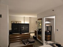 From head of bed looking at back of TV that swivels into area with sofa