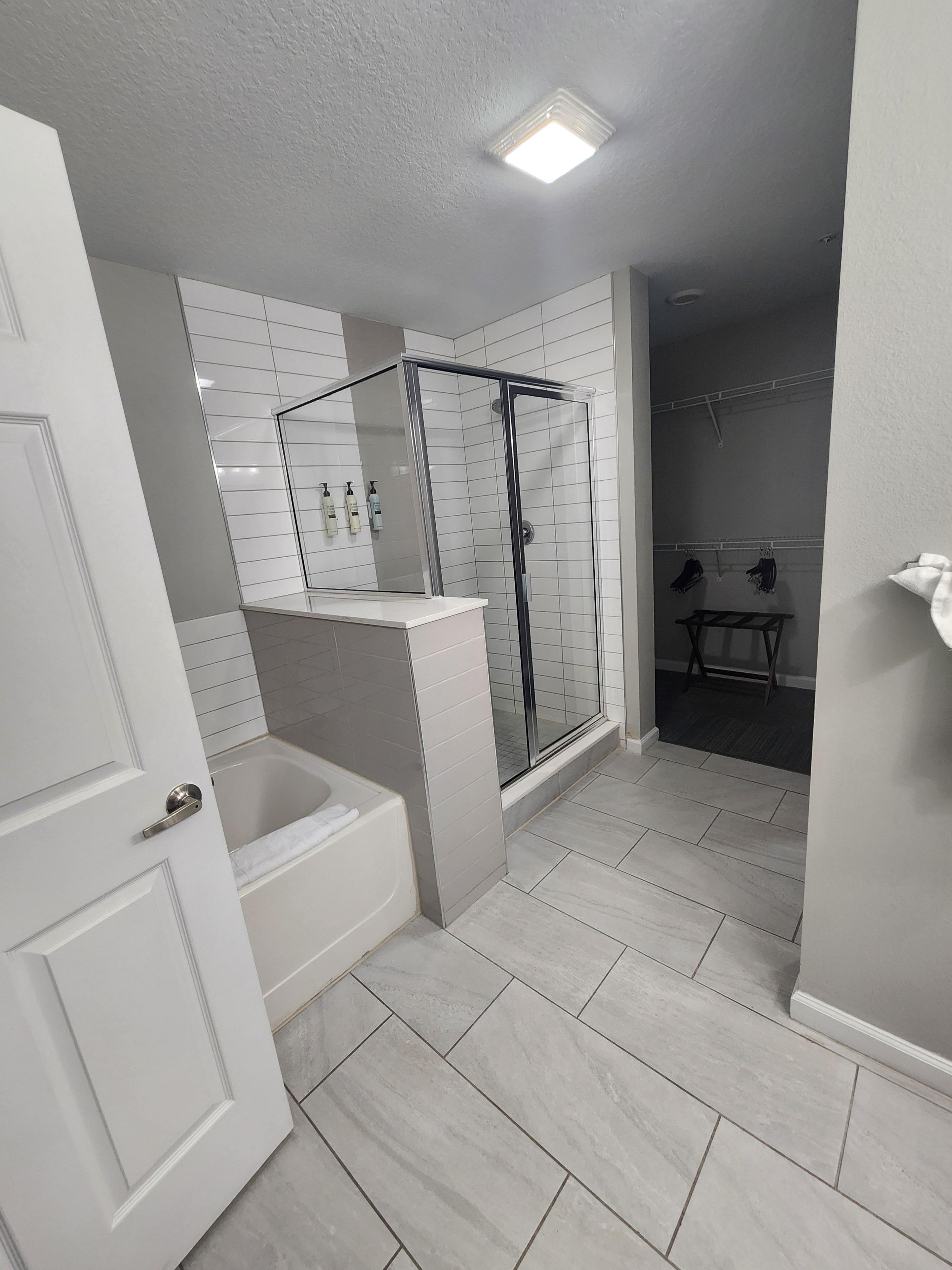 Primary bathroom, water closet, double sinks, and walk-in closet 