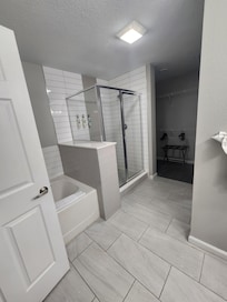 Primary bathroom, water closet, double sinks, and walk-in closet