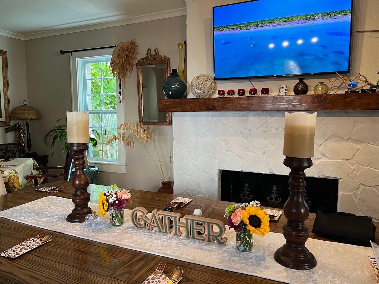 Farm style seating for 10. 4 chairs on one side, bench for 4 on opposite side, one chair at each end.