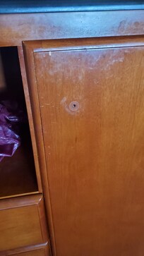 Front cabinet door showing missing doorknob.