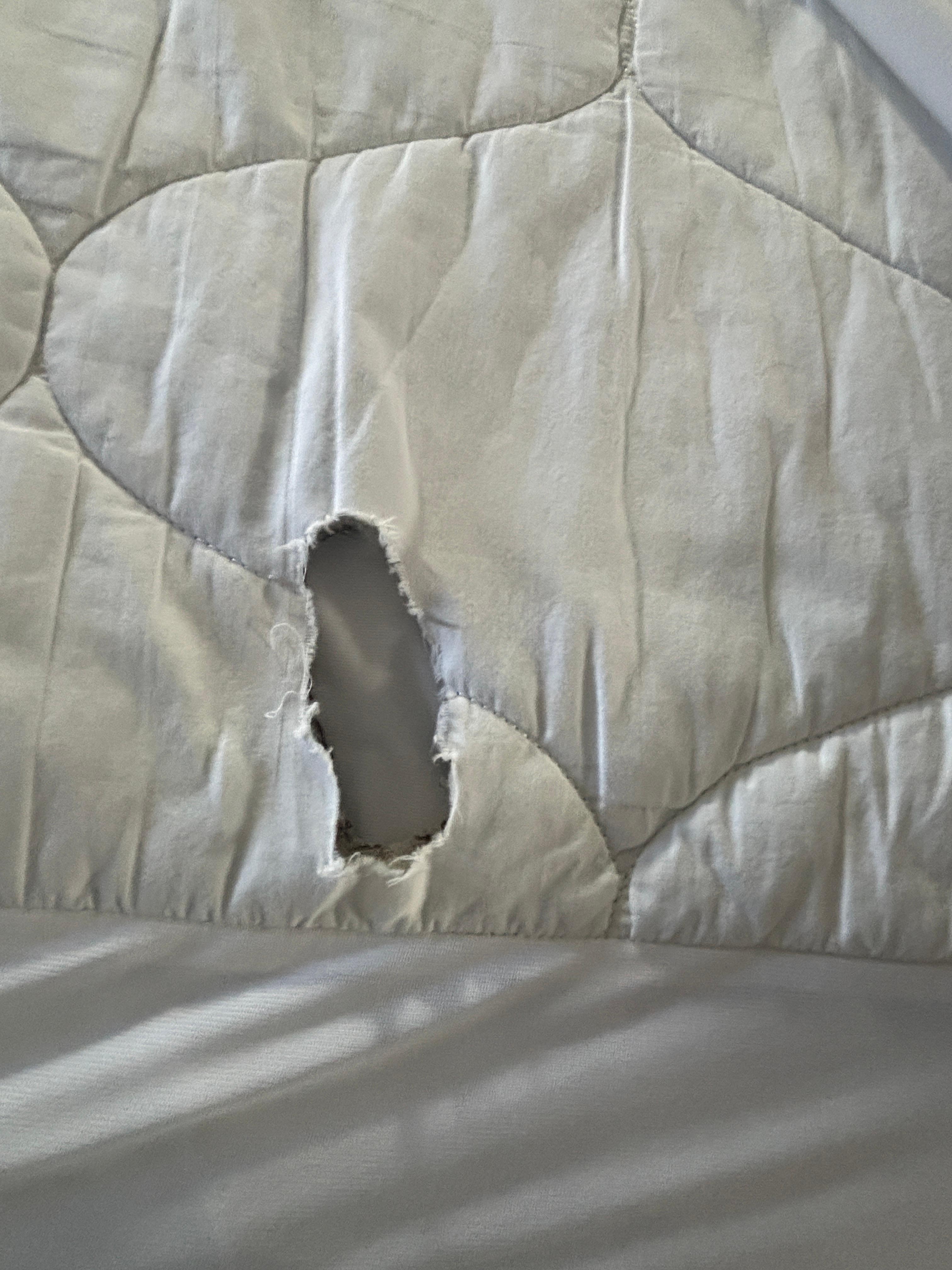 Holes cut in the mattress topper