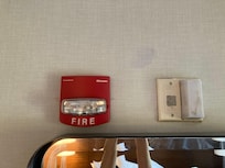 Living room above TV. inside red fire box & all around & inside white box.