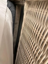 Dirty headboard behind pillow