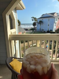 Having some iced tea while enjoying the sound of the waves.