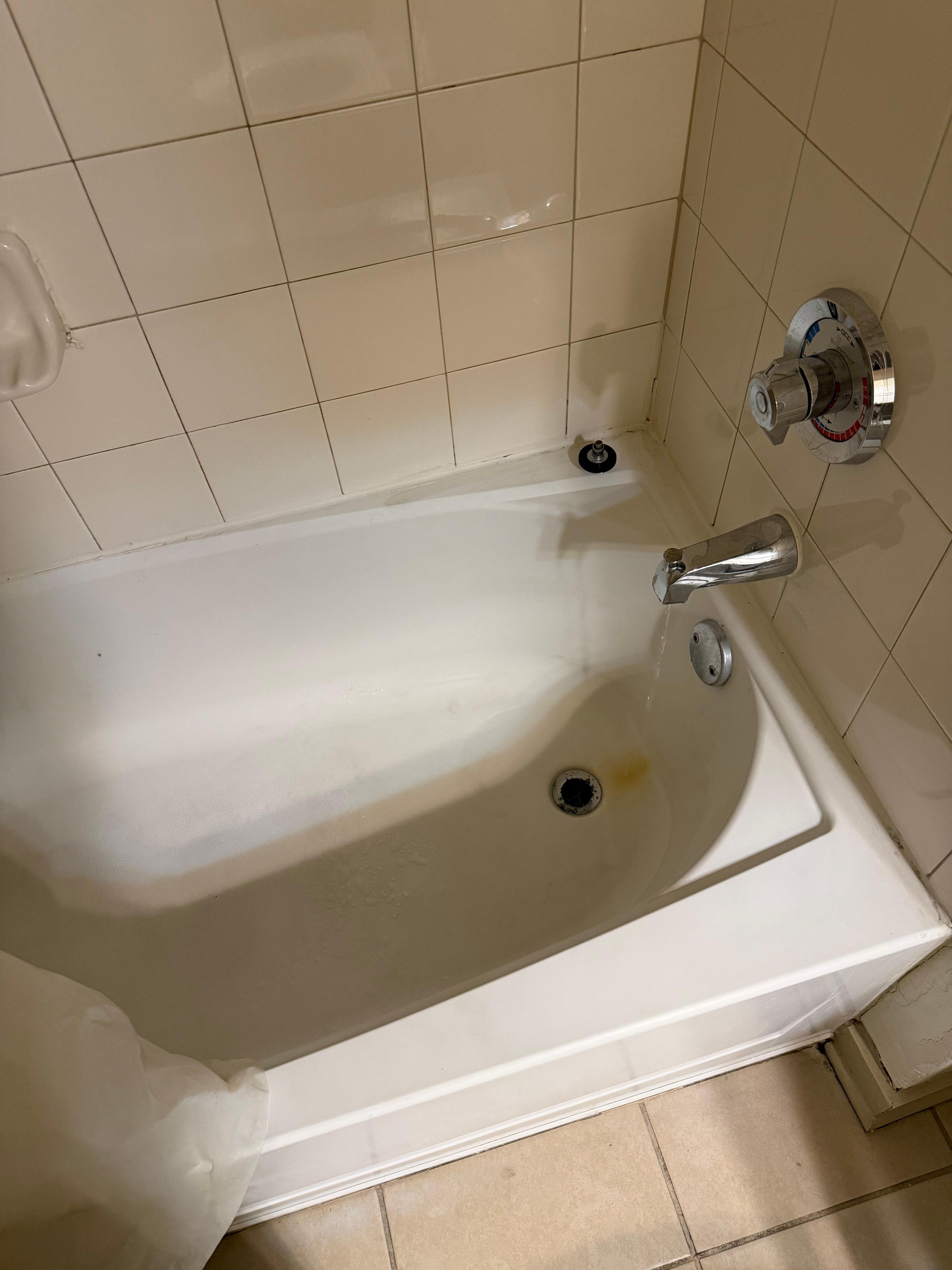 Dirty bathtub with water that wouldn’t stop running. 