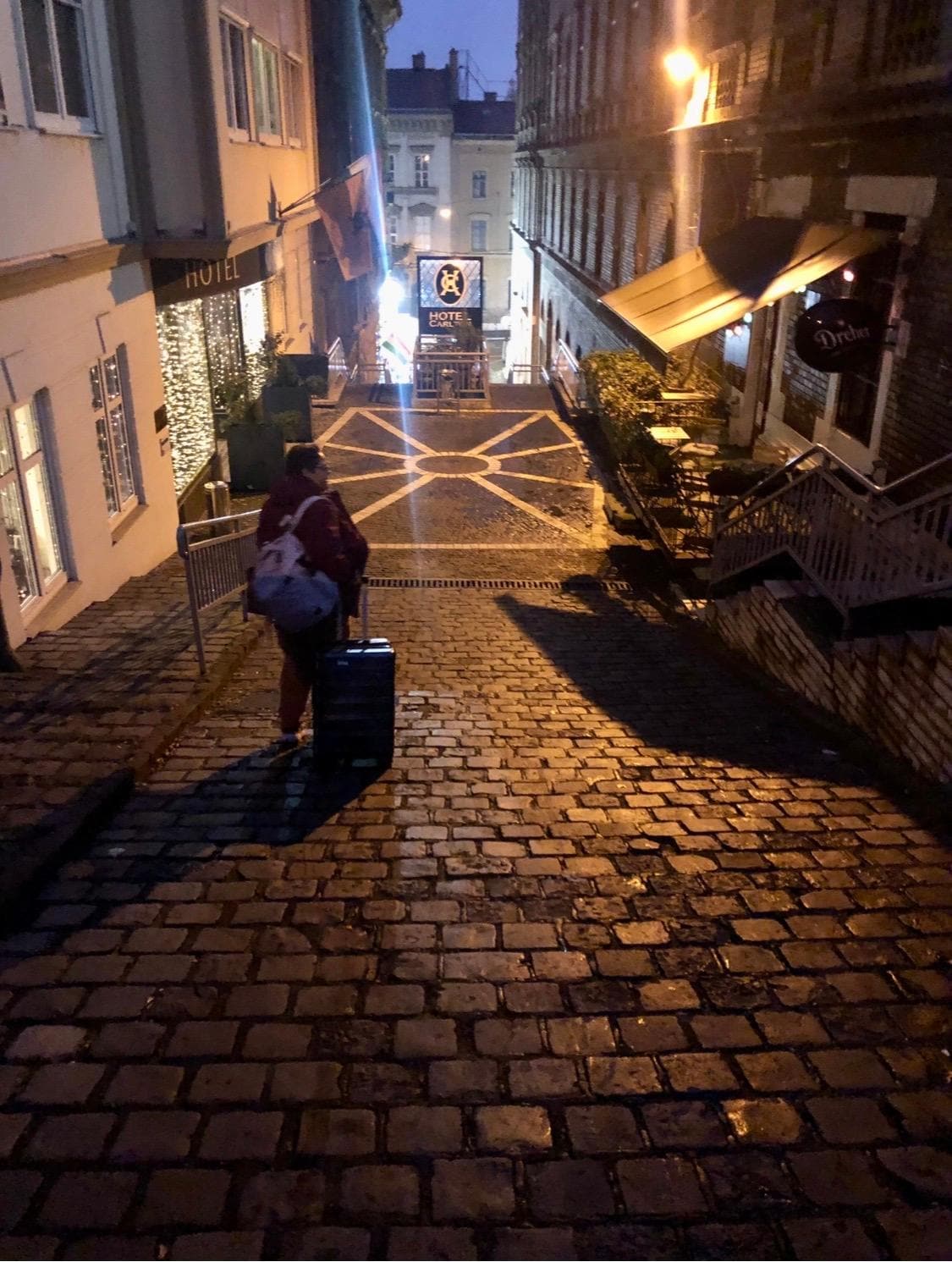 The alley and the hotel is on the left.