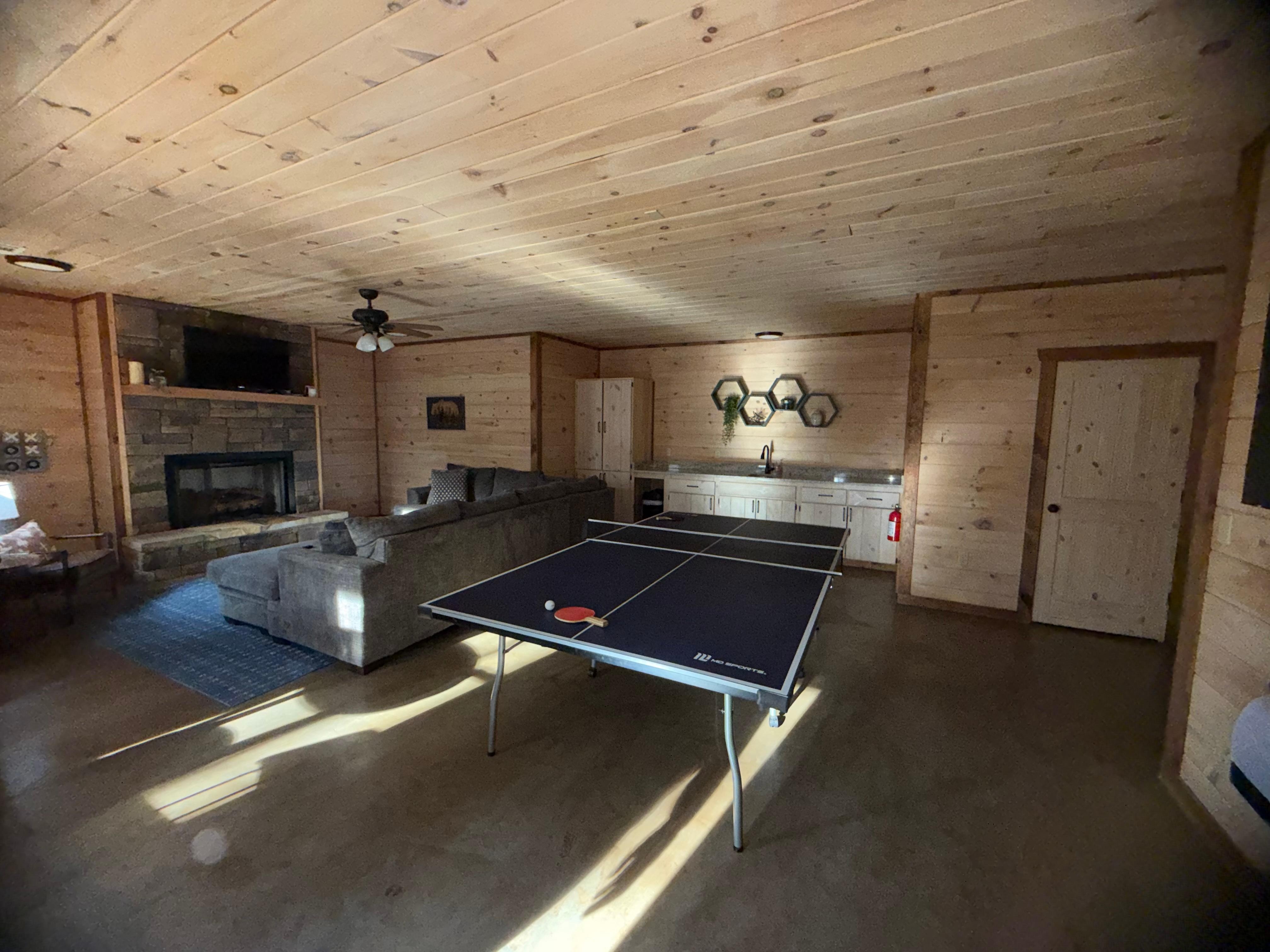 Spacious second living area on bottom floor with fun play area. 