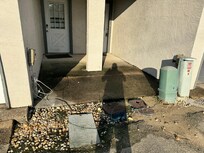 Dirt and wires in walkway to door