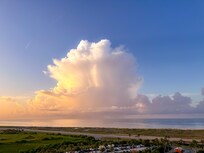 Thunderhead several miles offshore at sunrise.