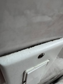 Gap exposing electrical wires a couple inches from running water