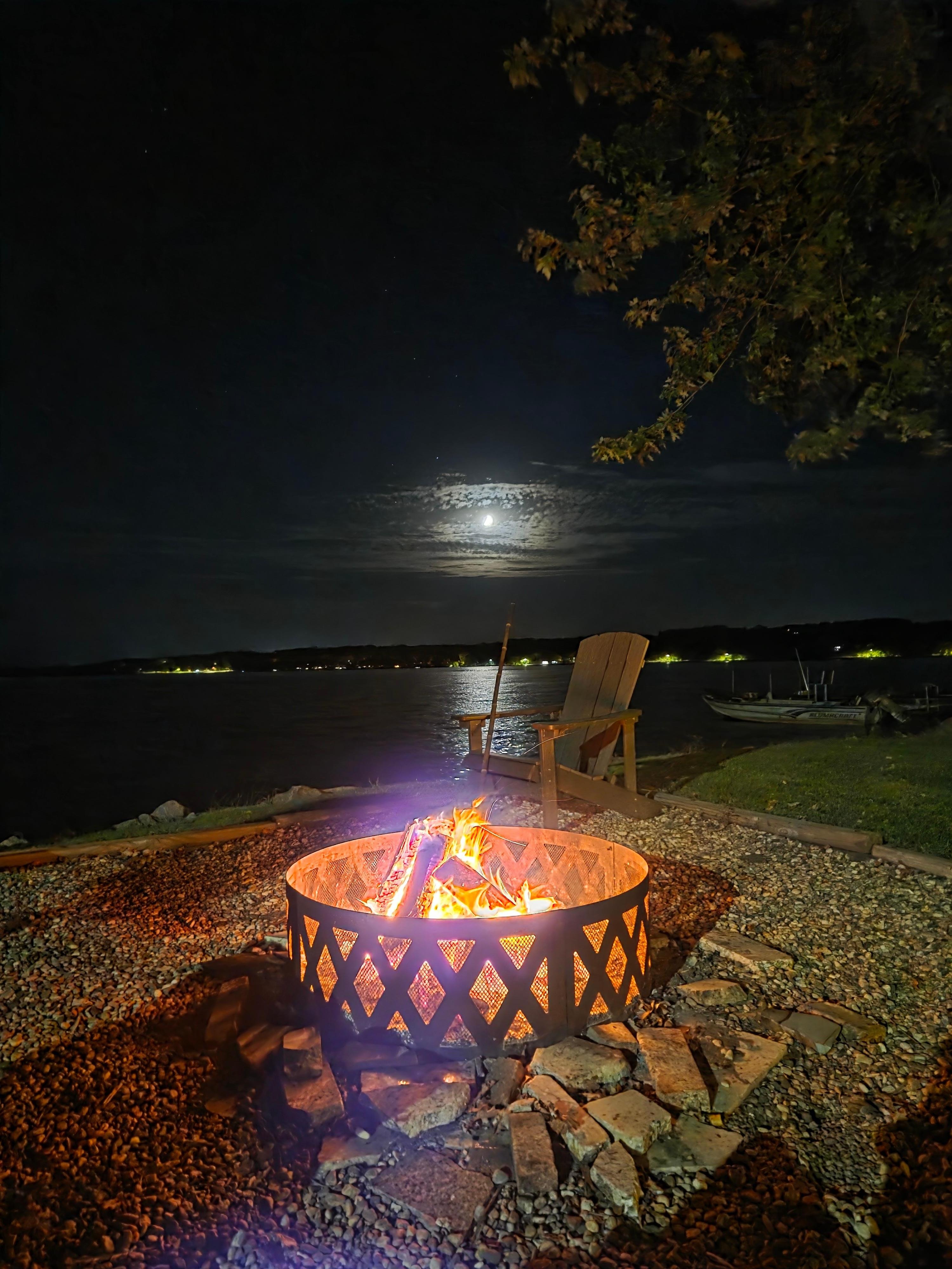 Lakeside firepit with the moon setting.  