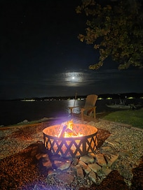 Lakeside firepit with the moon setting.