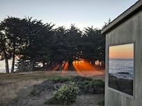 View from outside the house (on the deck) looking up coast at sunset.