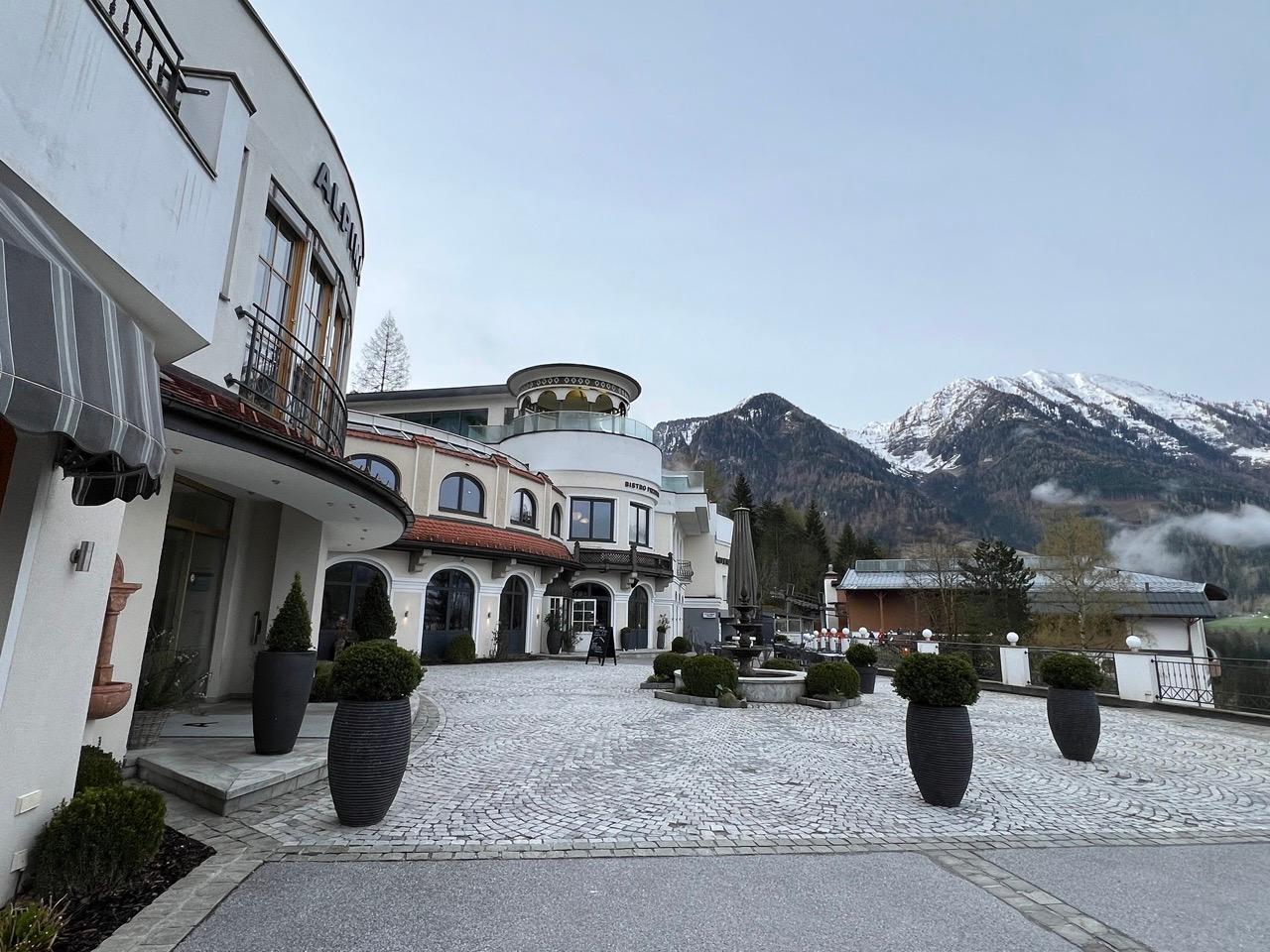 Walking to the hotel with the big mountains next to it.