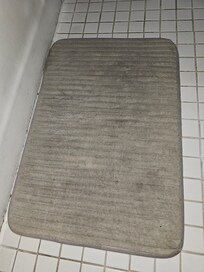 Dingy dirty bathroom mat