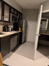 nice kitchen w/ stove, DW, fridge, microwave, dishes, coffee machine