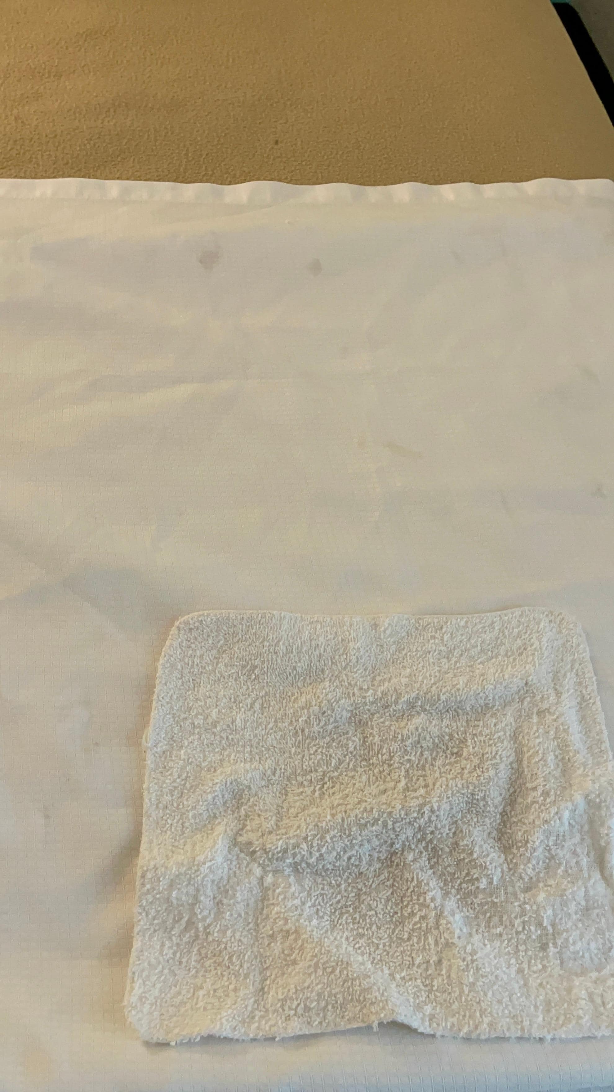 Extremely worn washcloth and stained sheets.