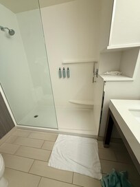 Half shower wall that does not block the water from soaking the floor creating an extremely slippery surface to step out of shower on. As you can see there aren’t any anti slip coated strips or anti slip rubber mats in or outside of the shower.
