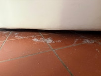 with a lot of dust and old toilet paper behind the bed from previous guests.