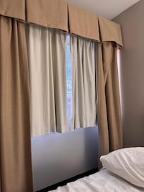 Broken curtains with weird blinking light outside