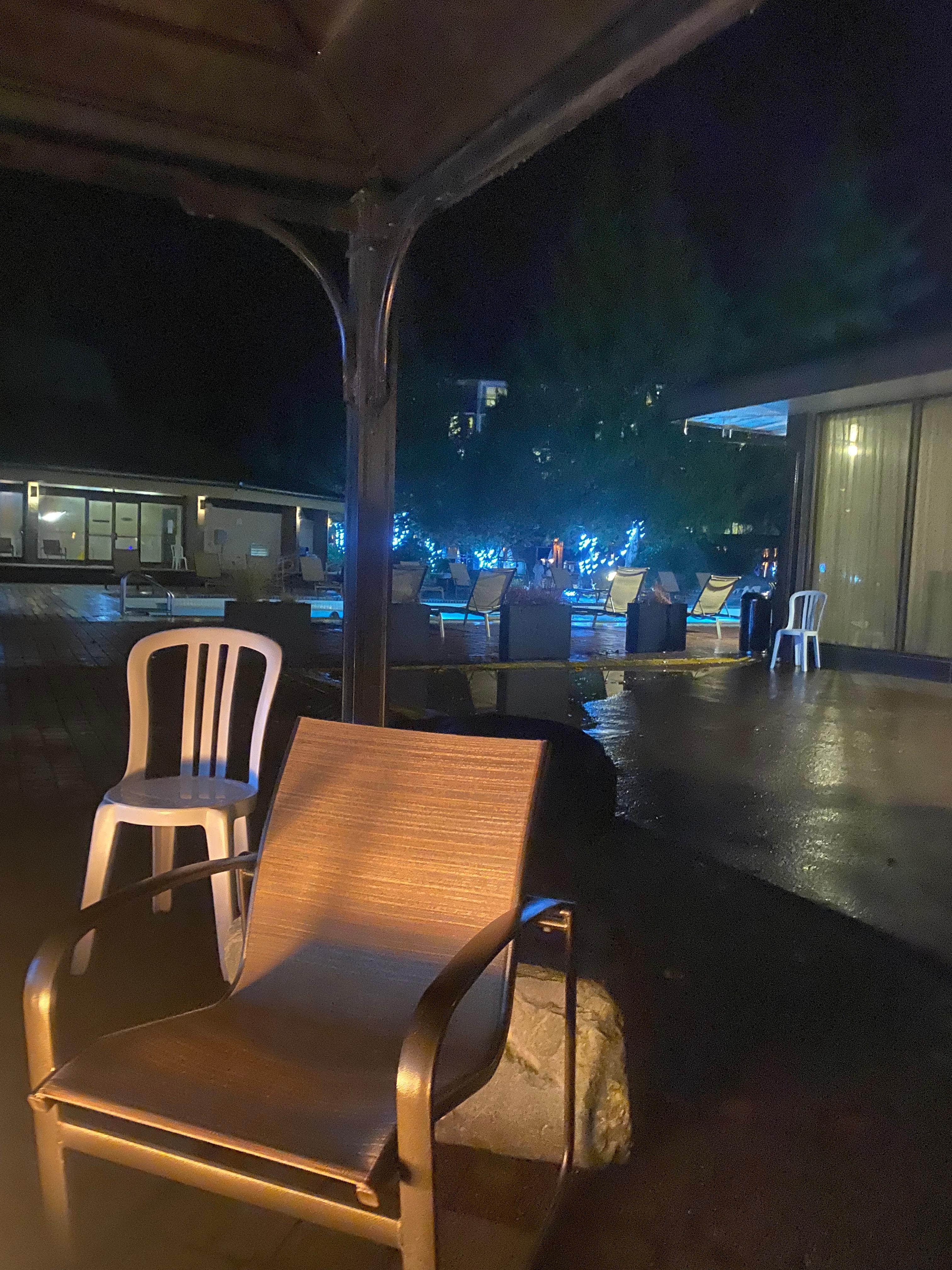 Outside at night warming up by the fire. Pools in view