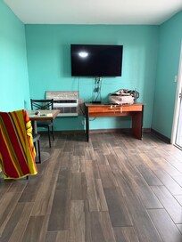 Foot of bed, left is bathroom, kitchen area.