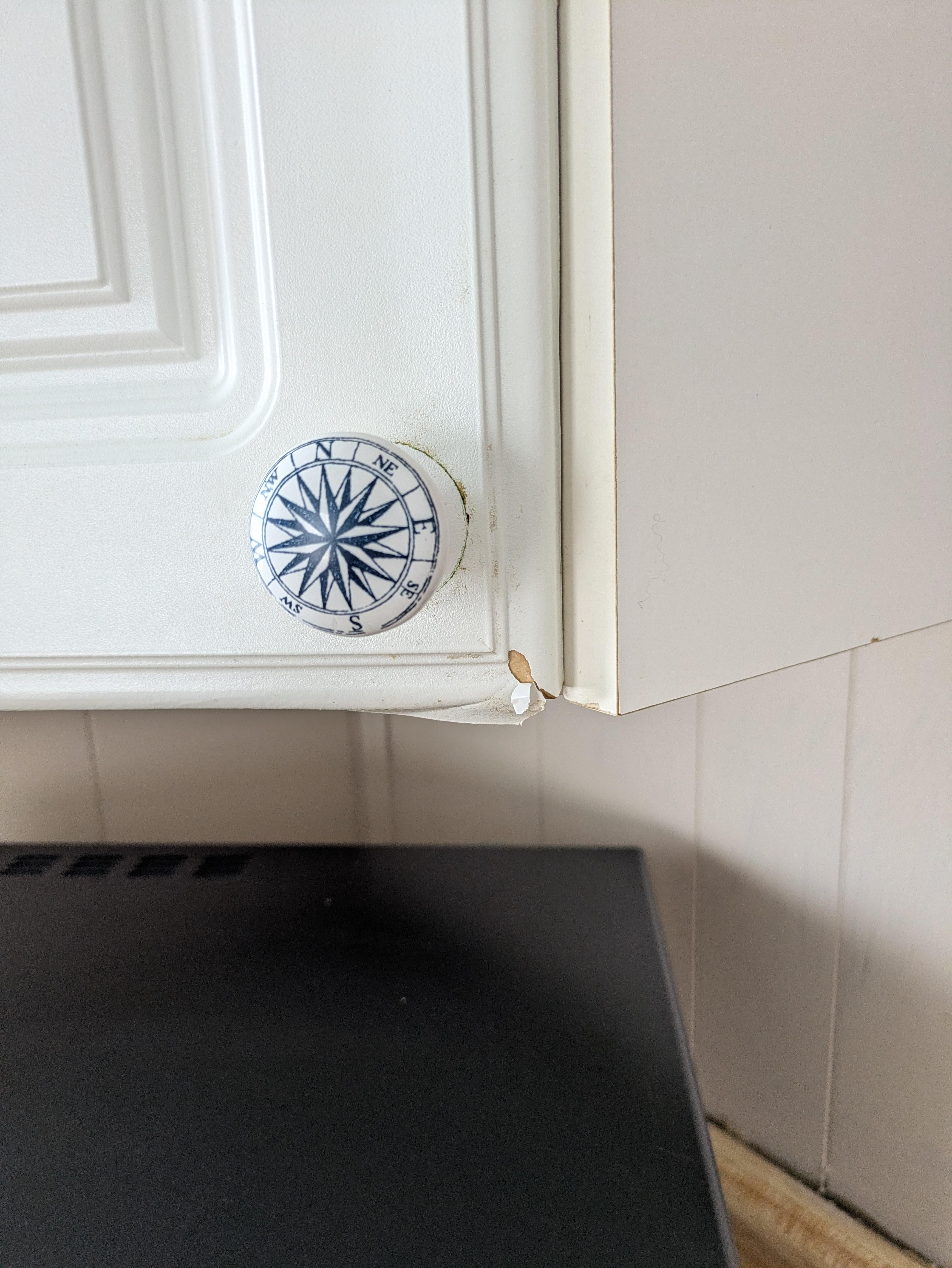 The kitchen cupboards had peeling on every door. 